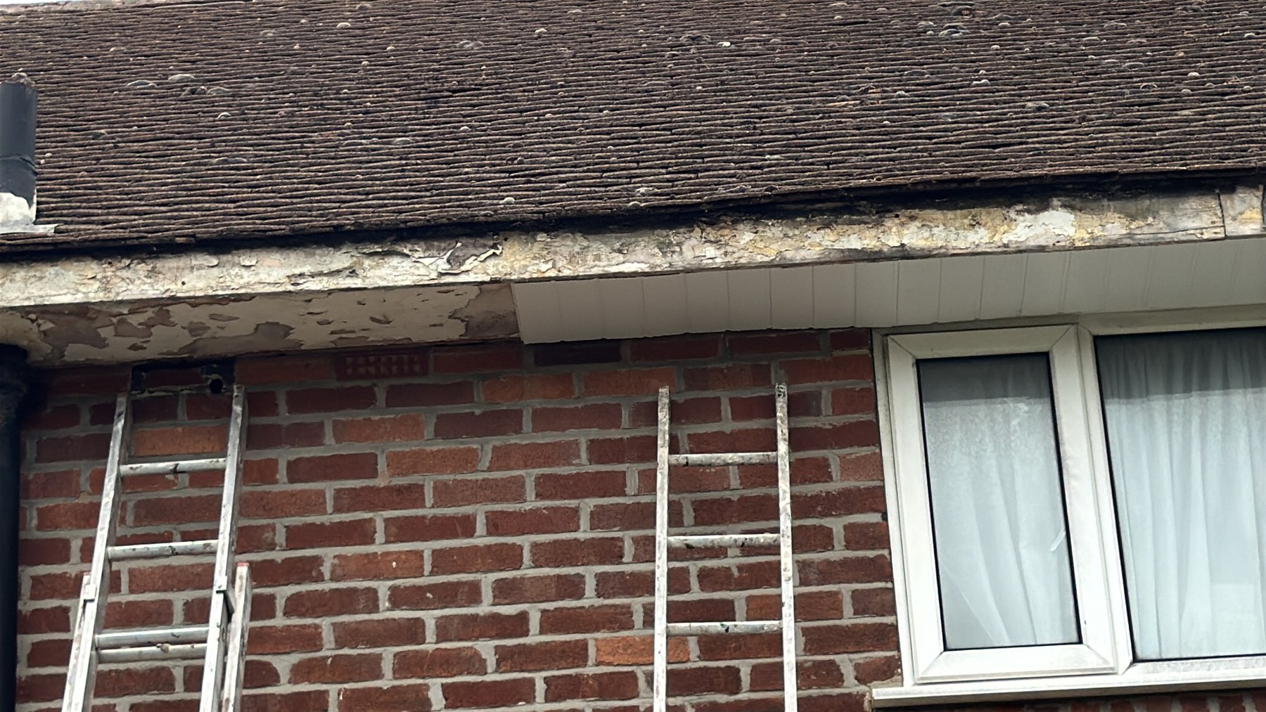 Damaged fascia and soffit before roofline work by Wavertree Roofing